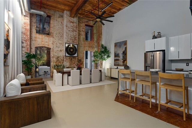 170 Boulevard Se 115E, Atlanta, GA 30312 - living room featuring a high ceiling, wooden ceiling, brick wall, finished concrete flooring, and ceiling fan