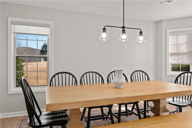 dining space featuring light wood-type flooring and a wealth of natural light