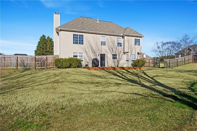 rear view of house featuring a lawn