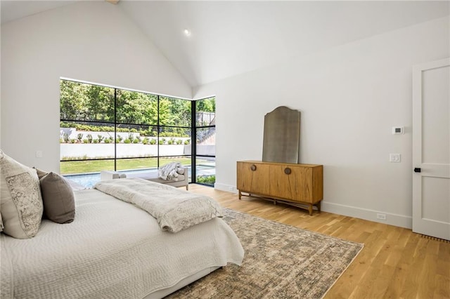 2515 Habersham Rd, Atlanta, GA 30305 - bedroom featuring high vaulted ceiling, access to outside, baseboards, and light wood-type flooring