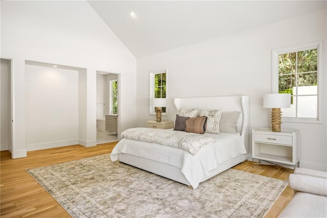 2515 Habersham Rd, Atlanta, GA 30305 - bedroom with multiple windows, high vaulted ceiling, light wood finished floors, baseboards, and ensuite bath