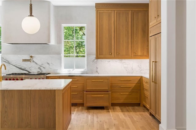 2515 Habersham Rd, Atlanta, GA 30305 - kitchen featuring light wood finished floors, backsplash, light stone countertops, and hanging light fixtures