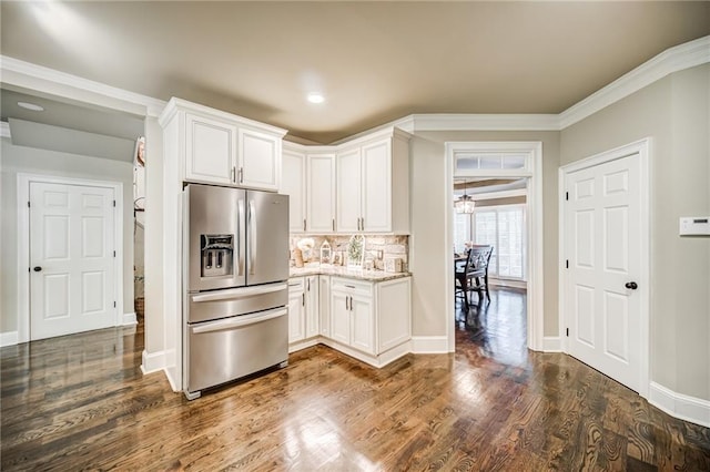 kitchen featuring light stone countertops, dark hardwood / wood-style floors, white cabinets, stainless steel refrigerator with ice dispenser, and crown molding