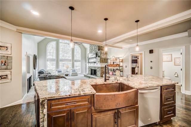 kitchen featuring stainless steel dishwasher, decorative light fixtures, dark hardwood / wood-style floors, and light stone counters