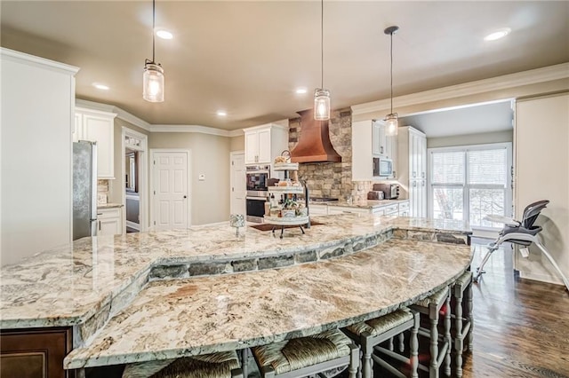 kitchen with dark hardwood / wood-style floors, white cabinetry, and decorative light fixtures