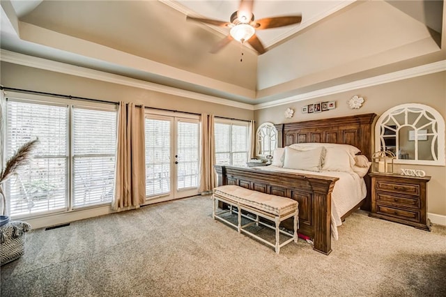 carpeted bedroom featuring ceiling fan, access to outside, a raised ceiling, and ornamental molding