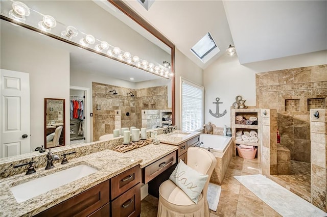 bathroom featuring lofted ceiling with skylight, plus walk in shower, tile floors, and dual bowl vanity