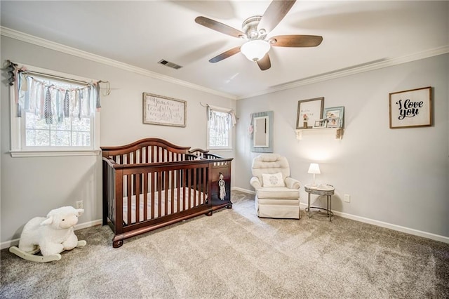 bedroom with a crib, crown molding, multiple windows, and light carpet