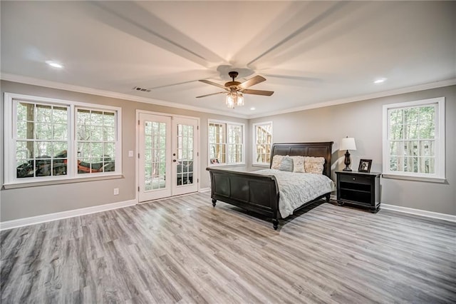 bedroom with ceiling fan, light hardwood / wood-style floors, multiple windows, and french doors