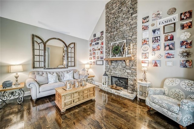 living room featuring a stone fireplace, dark hardwood / wood-style floors, and high vaulted ceiling