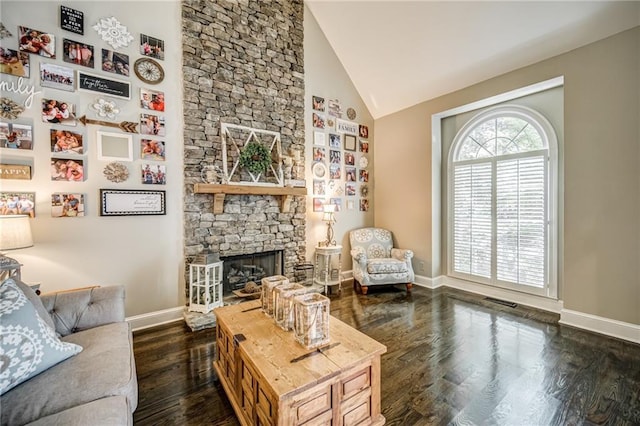 living room featuring a fireplace, high vaulted ceiling, and dark hardwood / wood-style flooring