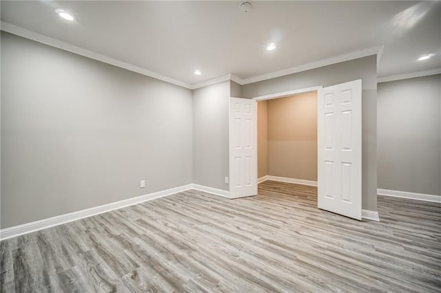 interior space featuring light wood-type flooring and ornamental molding