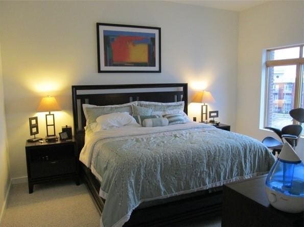 carpeted bedroom featuring baseboards