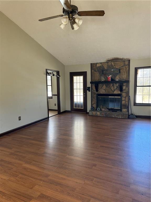 unfurnished living room featuring a healthy amount of sunlight, a fireplace, and wood finished floors