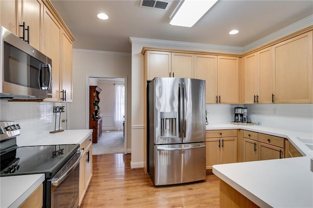 kitchen featuring stainless steel appliances, tasteful backsplash, visible vents, and light brown cabinets