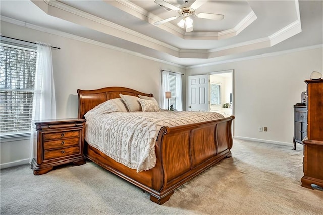 bedroom with light carpet, baseboards, crown molding, and a tray ceiling