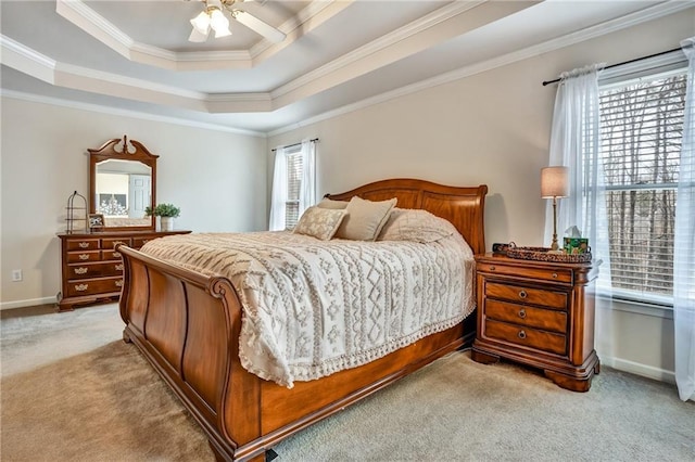 bedroom featuring baseboards, a raised ceiling, light colored carpet, and ornamental molding