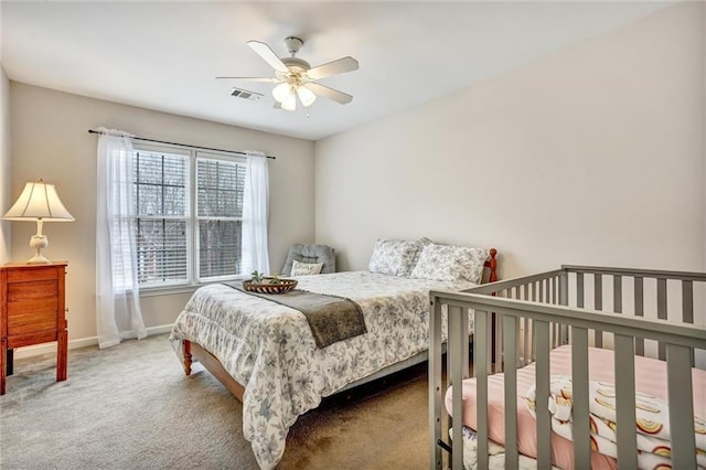 carpeted bedroom featuring visible vents, baseboards, and ceiling fan