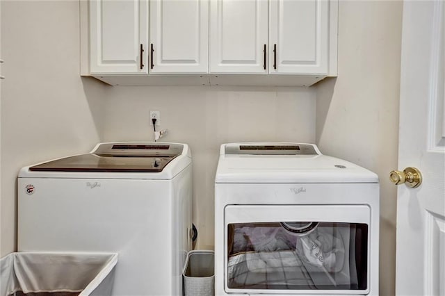 washroom with cabinet space and washing machine and clothes dryer