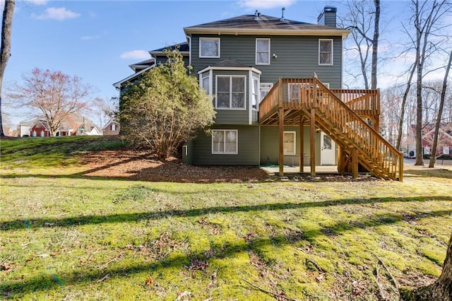 rear view of property with stairs, a lawn, a deck, and a chimney