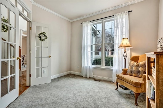 living area with french doors, carpet, a healthy amount of sunlight, and crown molding