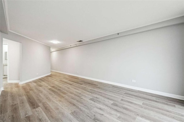 unfurnished room featuring crown molding and light hardwood / wood-style flooring