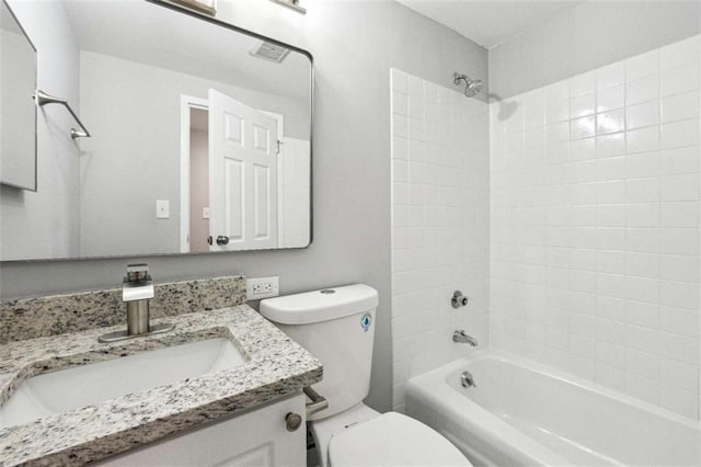 full bathroom with tiled shower / bath combo, vanity, and toilet