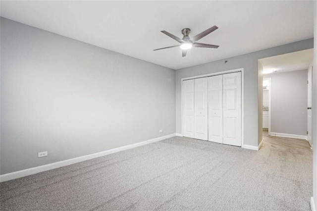 unfurnished bedroom with carpet flooring, ceiling fan, and a closet