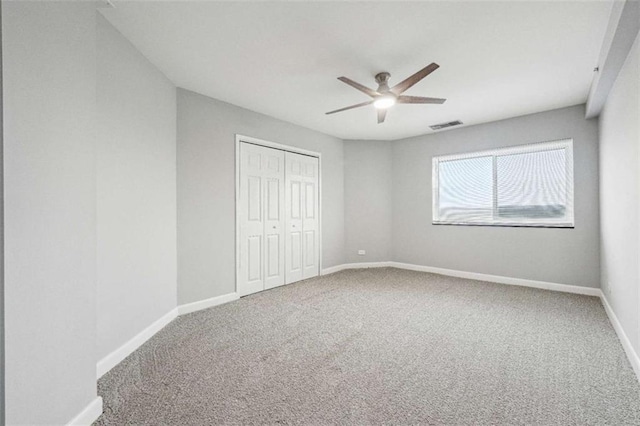 unfurnished bedroom featuring ceiling fan, carpet floors, and a closet