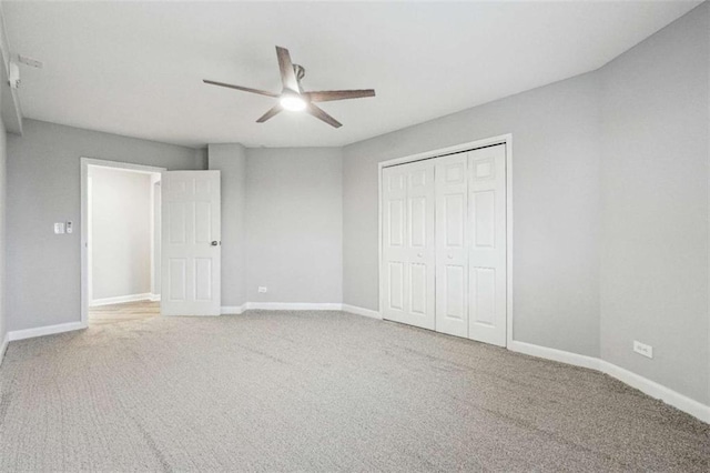 unfurnished bedroom with carpet floors, ceiling fan, and a closet