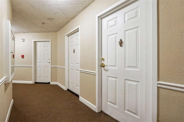 corridor with dark carpet