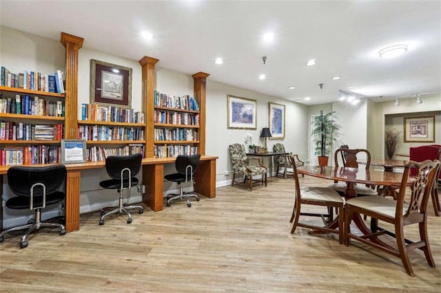 interior space with track lighting and light hardwood / wood-style floors