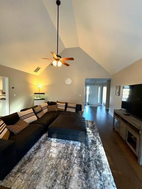 living room with lofted ceiling, ceiling fan, and wood finished floors