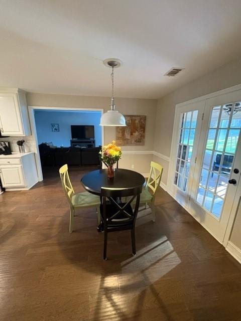 dining room featuring dark wood-style floors and visible vents