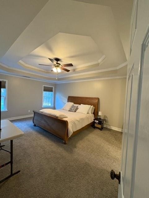 unfurnished bedroom with crown molding, a tray ceiling, carpet flooring, and baseboards