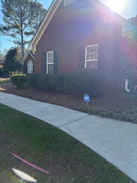 view of side of home featuring brick siding