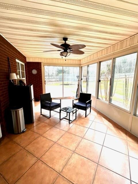 unfurnished sunroom with wood ceiling and ceiling fan