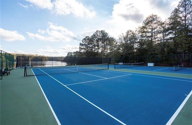 view of tennis court featuring fence