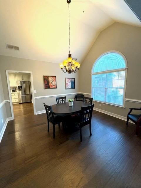 dining area featuring baseboards, visible vents, dark wood-style flooring, an inviting chandelier, and vaulted ceiling