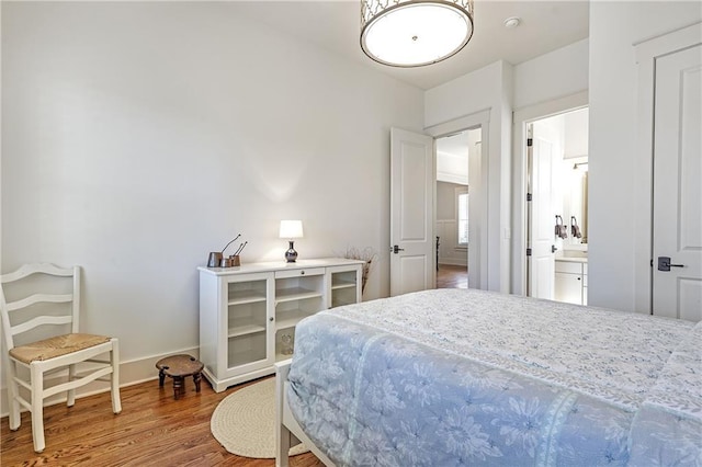 bedroom with wood finished floors and baseboards