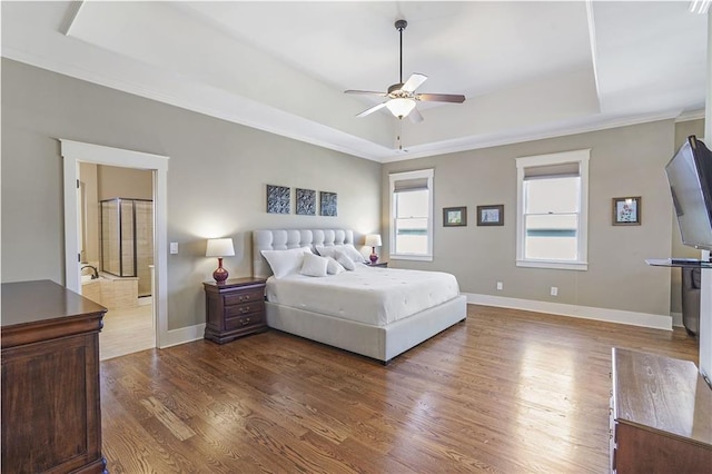 bedroom with a ceiling fan, a raised ceiling, dark wood finished floors, and baseboards