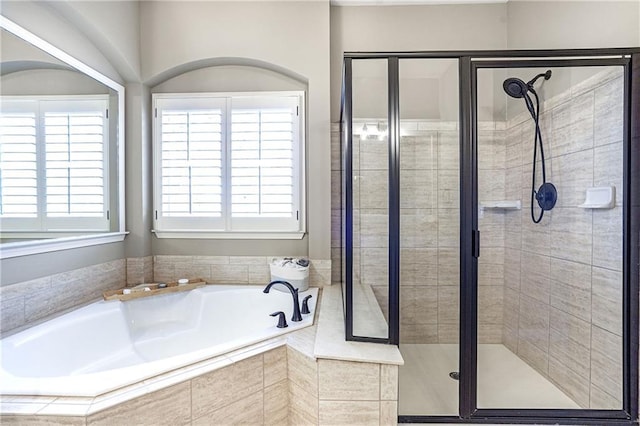 full bathroom with a garden tub and a shower stall