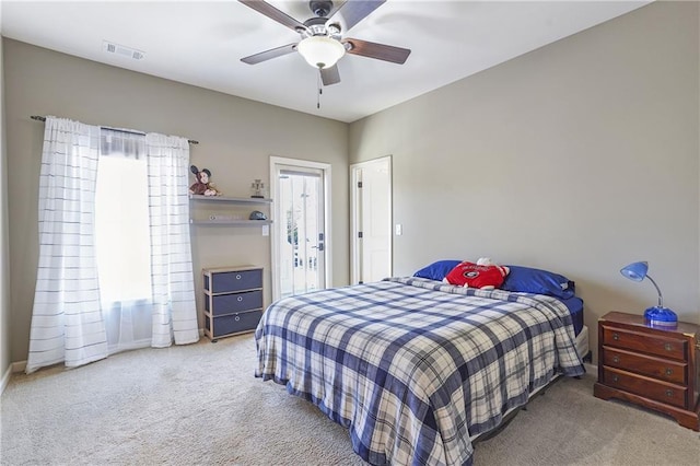 carpeted bedroom with visible vents and ceiling fan