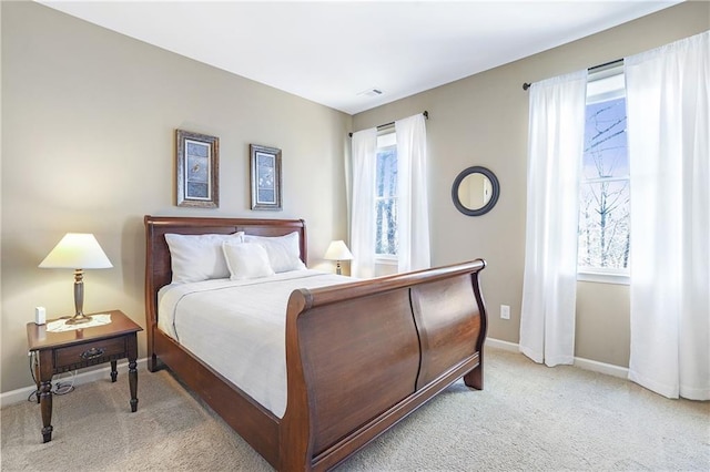 bedroom with light carpet, visible vents, and baseboards