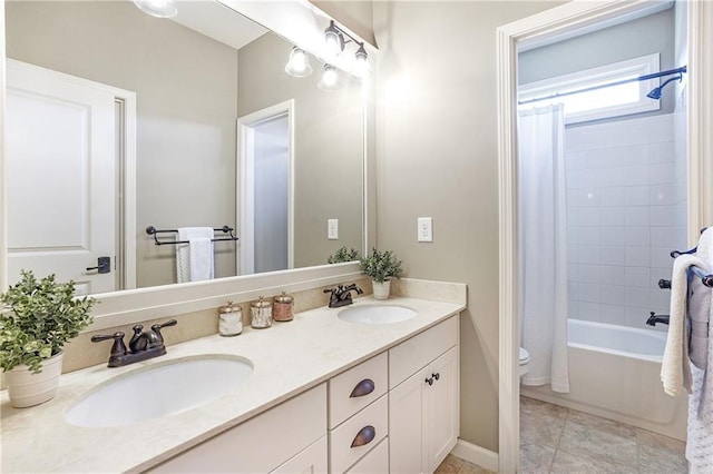 bathroom with shower / bath combination with curtain, a sink, toilet, and double vanity