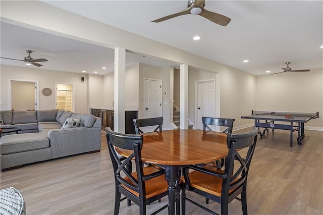 dining room featuring recessed lighting, light wood-style floors, a ceiling fan, baseboards, and stairs