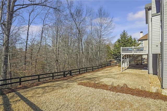 view of yard featuring a fenced backyard, stairs, and a wooden deck