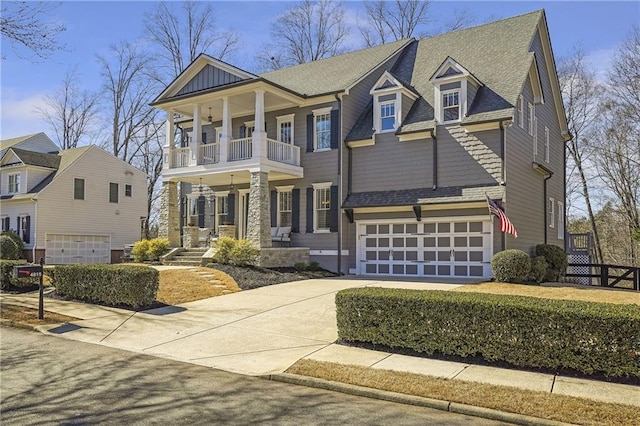 view of front facade featuring a garage, concrete driveway, roof with shingles, and a balcony