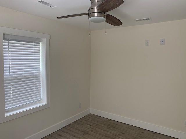 empty room with dark hardwood / wood-style floors and ceiling fan