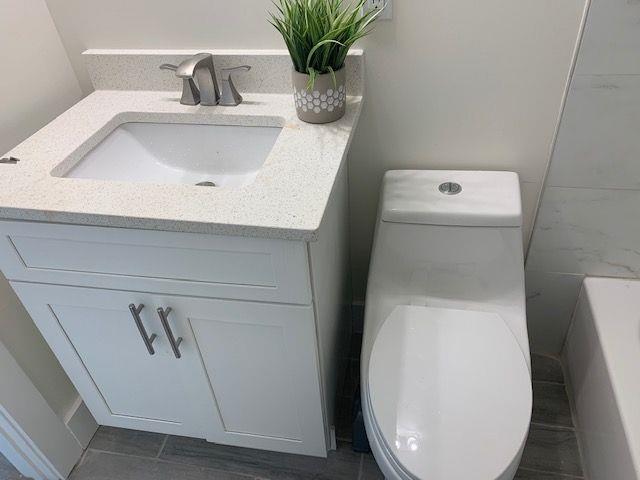 bathroom featuring vanity and toilet